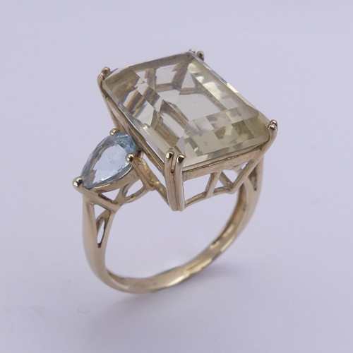 221 - A QVC citrine Dress Ring, the emerald cut stone 15.8mm x 11.9mm with a pear shaped pale blue stone o... 