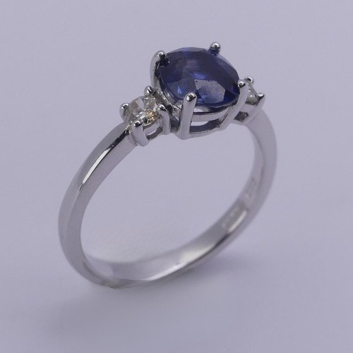 224 - A sapphire and diamond three stone Ring, the central oval cushion shaped sapphire approx. 6.25mm x 6... 