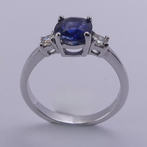 224 - A sapphire and diamond three stone Ring, the central oval cushion shaped sapphire approx. 6.25mm x 6... 