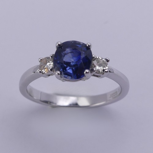 224 - A sapphire and diamond three stone Ring, the central oval cushion shaped sapphire approx. 6.25mm x 6... 