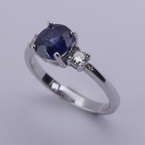 224 - A sapphire and diamond three stone Ring, the central oval cushion shaped sapphire approx. 6.25mm x 6... 