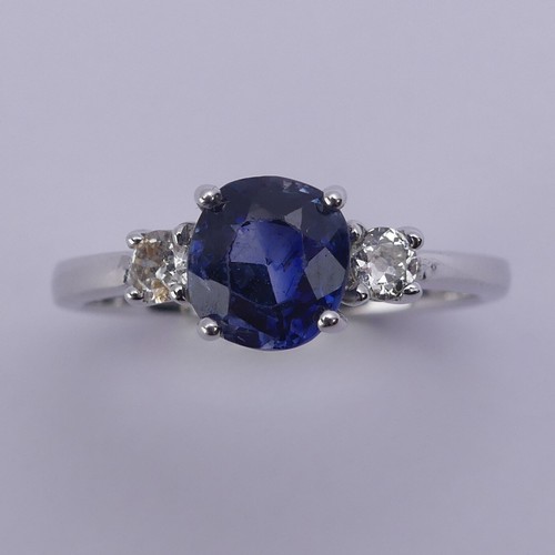 224 - A sapphire and diamond three stone Ring, the central oval cushion shaped sapphire approx. 6.25mm x 6... 