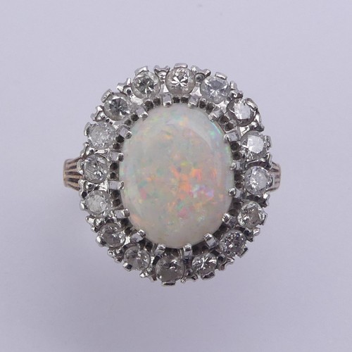 226 - An opal and diamond cluster Ring, the central oval opal 12mm long surrounded by sixteen circular dia... 