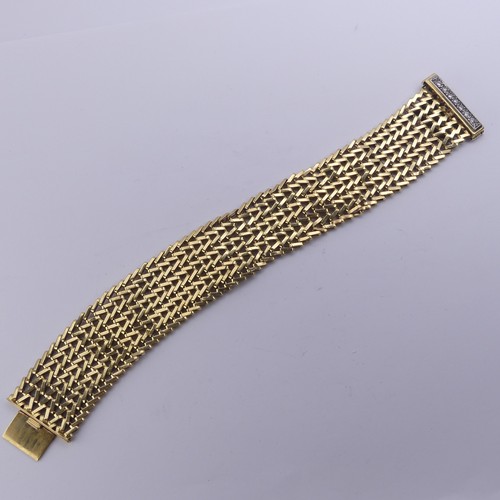 273 - An 18ct yellow gold mesh Bracelet, with integral clasp and diamond set safety bar, 2.8cm wide, 19cm ... 