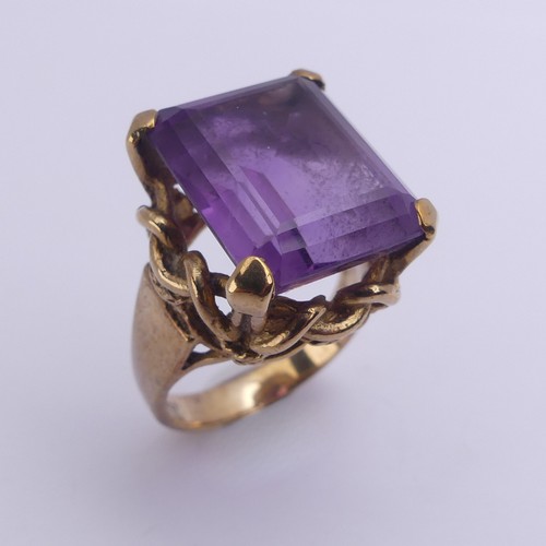 228 - An amethyst Dress Ring, the emerald cut stone 15.8mm x 13.3mm, in ropework mount on plain 9ct gold s... 