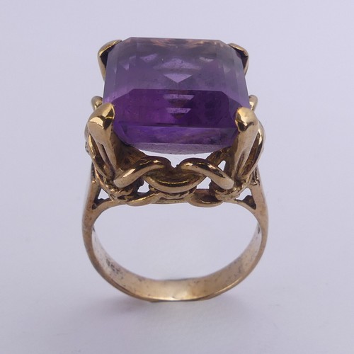 228 - An amethyst Dress Ring, the emerald cut stone 15.8mm x 13.3mm, in ropework mount on plain 9ct gold s... 