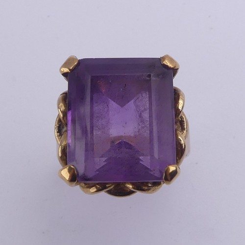 228 - An amethyst Dress Ring, the emerald cut stone 15.8mm x 13.3mm, in ropework mount on plain 9ct gold s... 