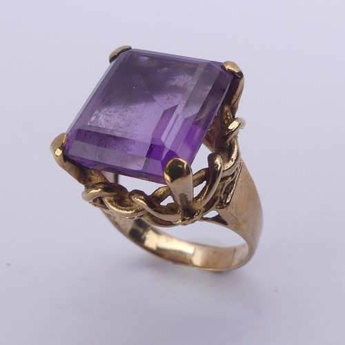 228 - An amethyst Dress Ring, the emerald cut stone 15.8mm x 13.3mm, in ropework mount on plain 9ct gold s... 