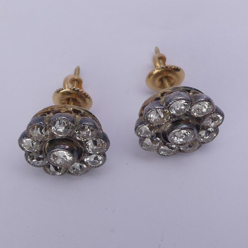 282 - A pair of diamond flowerhead cluster Earrings, the old cut stones millegrain set in white metal and ... 