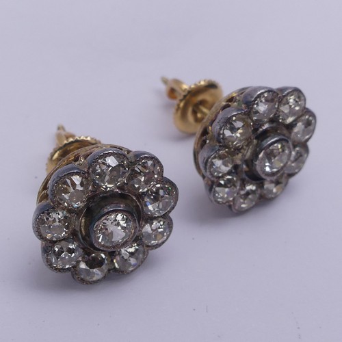 282 - A pair of diamond flowerhead cluster Earrings, the old cut stones millegrain set in white metal and ... 