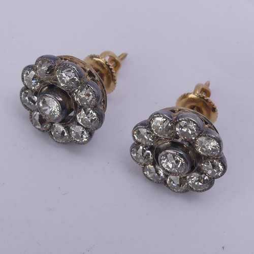 282 - A pair of diamond flowerhead cluster Earrings, the old cut stones millegrain set in white metal and ... 