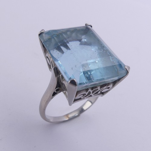 232 - A large aquamarine Dress Ring, the stone approx. 20ct (18mm x 14.4mm x 11.3mm) mounted in unmarked w... 