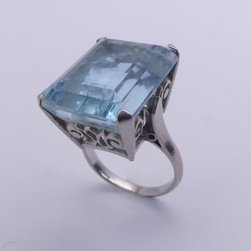 232 - A large aquamarine Dress Ring, the stone approx. 20ct (18mm x 14.4mm x 11.3mm) mounted in unmarked w... 