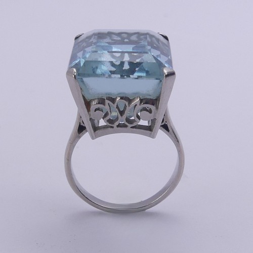 232 - A large aquamarine Dress Ring, the stone approx. 20ct (18mm x 14.4mm x 11.3mm) mounted in unmarked w... 