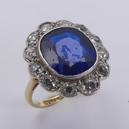 233 - A blue stone and diamond cluster Ring, the cushion shaped central facetted blue stone, possibly synt... 