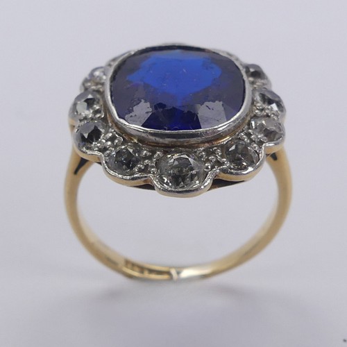 233 - A blue stone and diamond cluster Ring, the cushion shaped central facetted blue stone, possibly synt... 