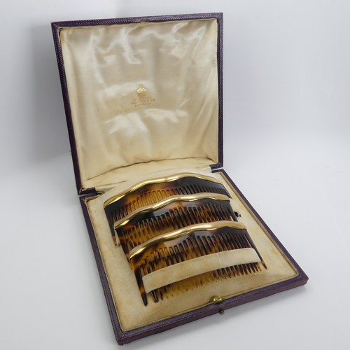 330 - Asprey; An early 20thC cased trio of graduated tortoiseshell Combs / Hair Ornaments, of domed form w... 