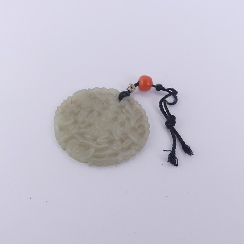 332 - A Chinese carved and pierced circular Plaque / Pendant, 4.3cm diameter, 8.2g.