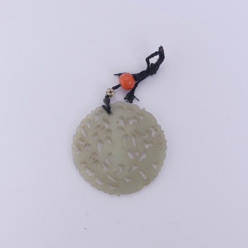 332 - A Chinese carved and pierced circular Plaque / Pendant, 4.3cm diameter, 8.2g.