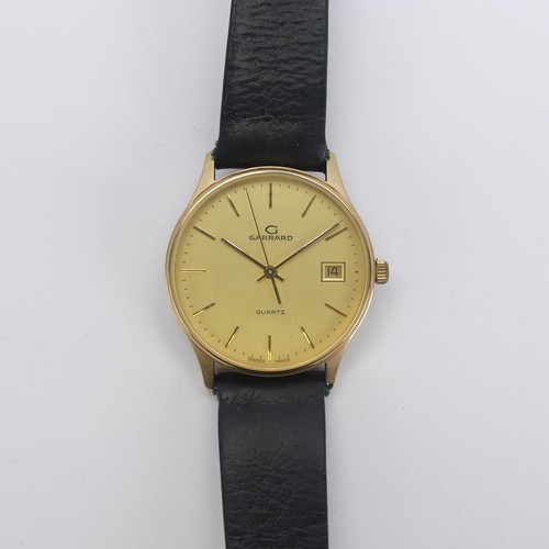 129 - A 9ct yellow gold Garrard quartz Wristwatch, the reverse with presentation inscription, 33mm diamete... 