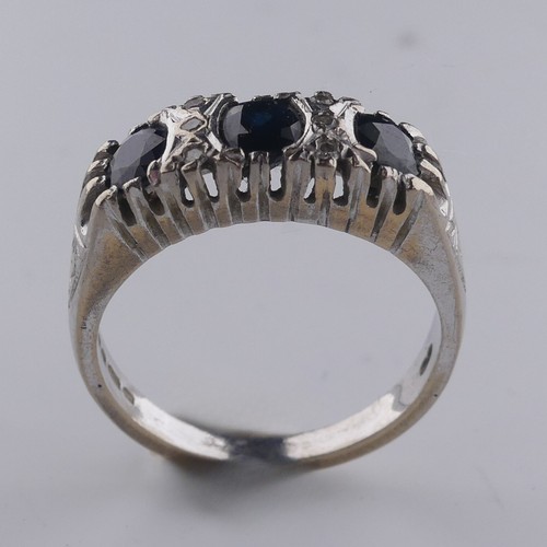 176 - A three stone sapphire Ring, the cushion shaped facetted stones with three diamond points vertically... 