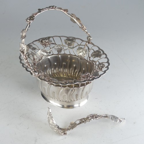 121 - A Continental silver swing handled Basket, of oval form, the rim pierced with fruit and vine decorat... 