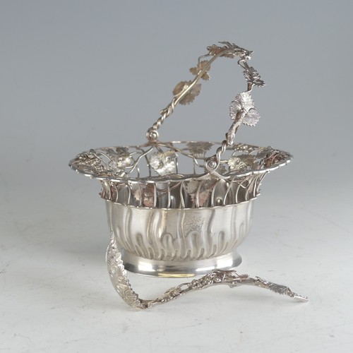 121 - A Continental silver swing handled Basket, of oval form, the rim pierced with fruit and vine decorat... 