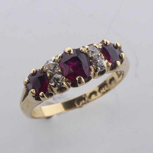 189 - A ruby and diamond Ring, the three graduated rubies with two small diamonds vertically set between e... 