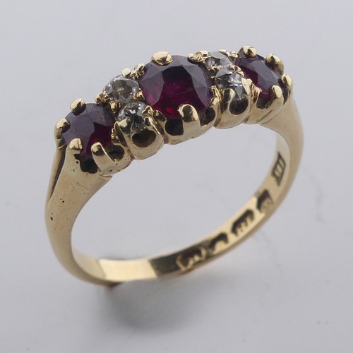 189 - A ruby and diamond Ring, the three graduated rubies with two small diamonds vertically set between e... 