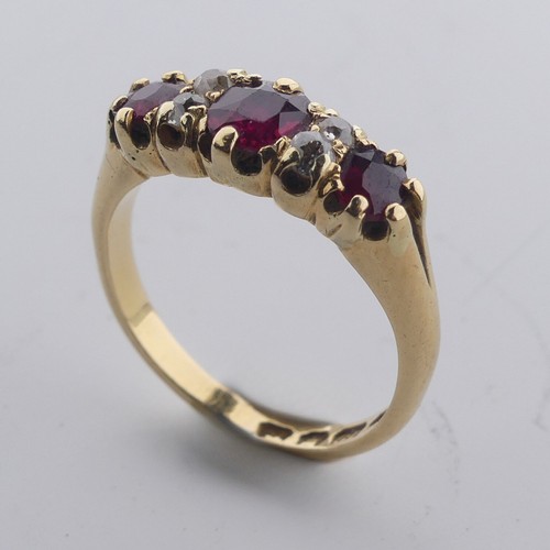 189 - A ruby and diamond Ring, the three graduated rubies with two small diamonds vertically set between e... 