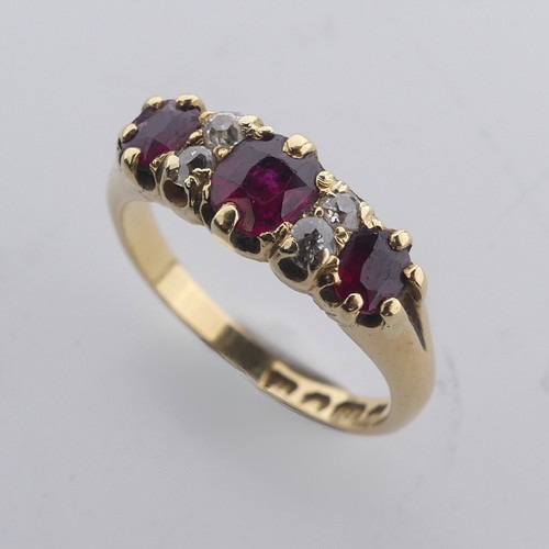 189 - A ruby and diamond Ring, the three graduated rubies with two small diamonds vertically set between e... 