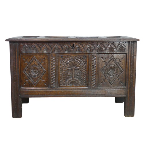 519 - A 17th century and later oak carved Coffer, paneled top over heavily carved base, the center panel d... 