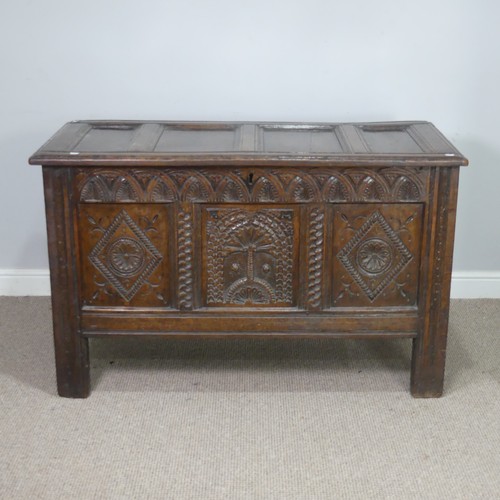 519 - A 17th century and later oak carved Coffer, paneled top over heavily carved base, the center panel d... 