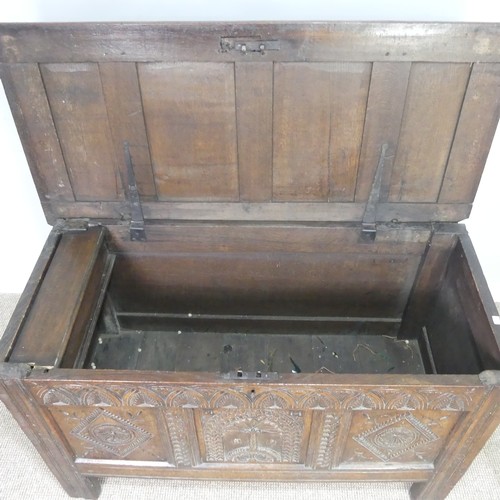 519 - A 17th century and later oak carved Coffer, paneled top over heavily carved base, the center panel d... 