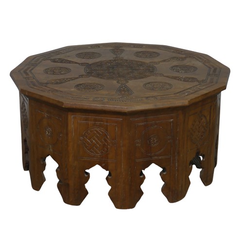 521 - An Arts and Crafts Anglo-Indian centre Table, the dodecagon top carved with stylised flowers and geo... 