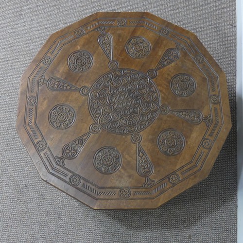 521 - An Arts and Crafts Anglo-Indian centre Table, the dodecagon top carved with stylised flowers and geo... 