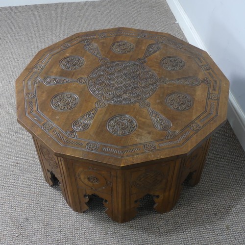 521 - An Arts and Crafts Anglo-Indian centre Table, the dodecagon top carved with stylised flowers and geo... 