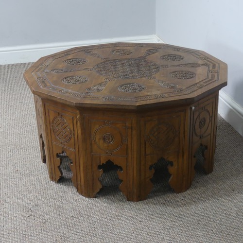 521 - An Arts and Crafts Anglo-Indian centre Table, the dodecagon top carved with stylised flowers and geo... 