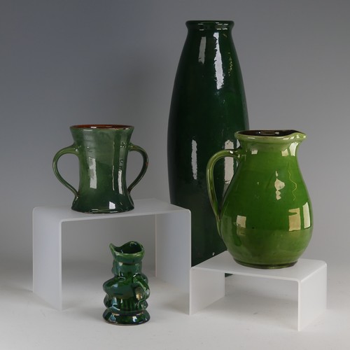 32 - Edward Sadler; a Devonia Art Pottery Character Jug, in deep green glaze, incised signature to base, ... 