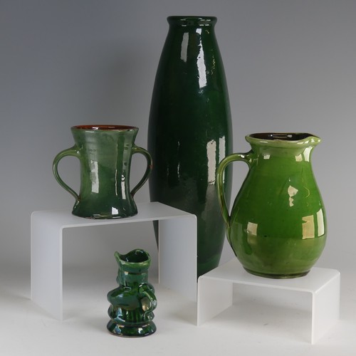 32 - Edward Sadler; a Devonia Art Pottery Character Jug, in deep green glaze, incised signature to base, ... 