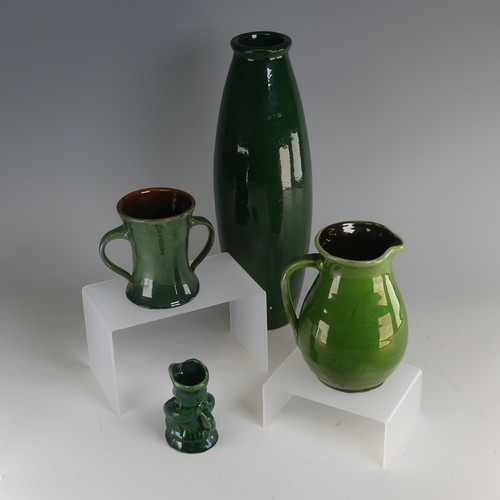 32 - Edward Sadler; a Devonia Art Pottery Character Jug, in deep green glaze, incised signature to base, ... 