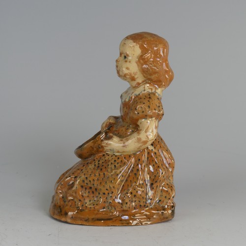 27 - A North Devon pottery figure of a Young Girl, possibly by Edwin Beer Fishley, modelled seated clutch... 