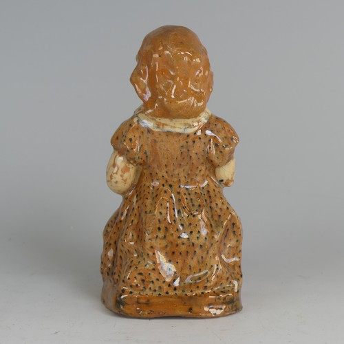 27 - A North Devon pottery figure of a Young Girl, possibly by Edwin Beer Fishley, modelled seated clutch... 