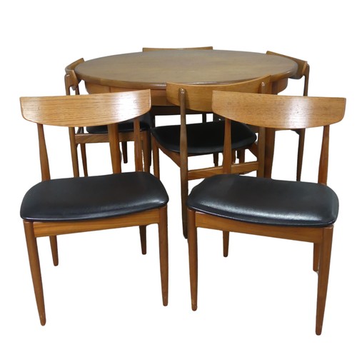 565 - A mid-20th century G-Plan teak dining Table and six Chairs, probably designed by E Gomme, the circul... 