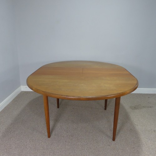 565 - A mid-20th century G-Plan teak dining Table and six Chairs, probably designed by E Gomme, the circul... 