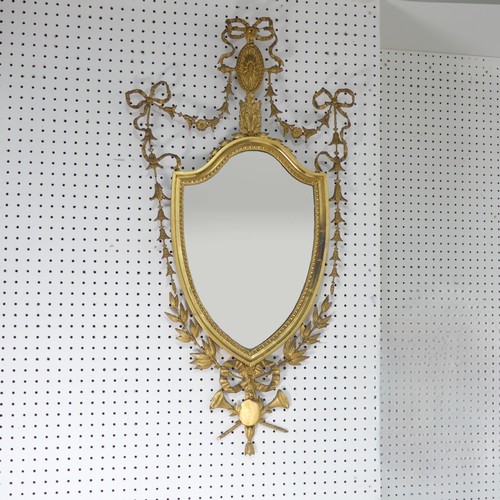 510 - A giltwood framed wall Mirror in George III style, the frame decorated with foliate swags and bows, ... 