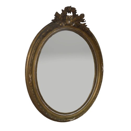 553 - A near pair of 19th century style giltwood wall Mirrors, both of oval form and with carved pediments... 