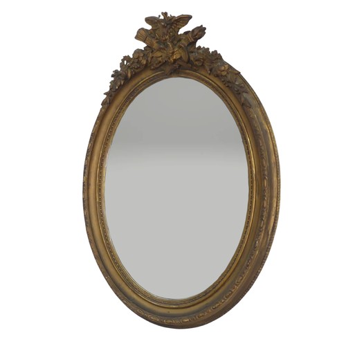 553 - A near pair of 19th century style giltwood wall Mirrors, both of oval form and with carved pediments... 