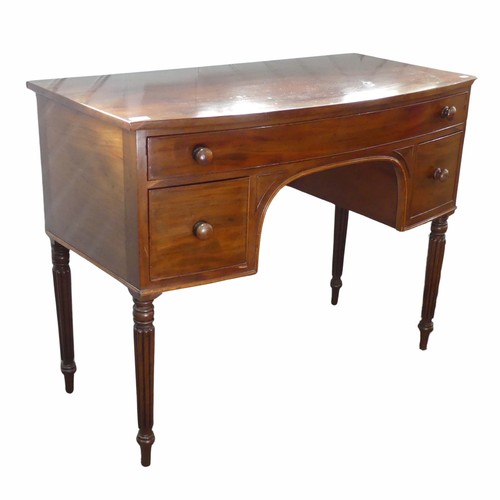 589 - A William IV style mahogany bow-front dressing Table, frieze drawer over kneehole, flanked by deep d... 