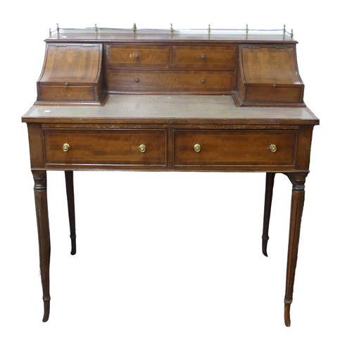 604 - An Edwardian Carlton House type Desk, the top with three quarter brass gallery, above hinged covers ... 